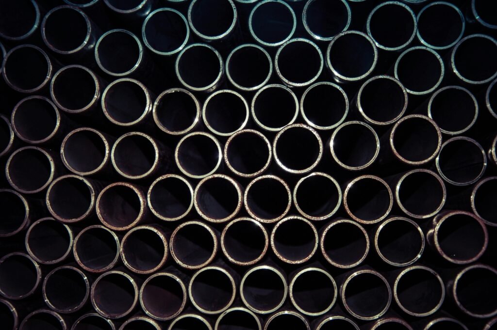 A detailed macro shot of stacked metal tubes forming a circular pattern, highlighting industrial design.