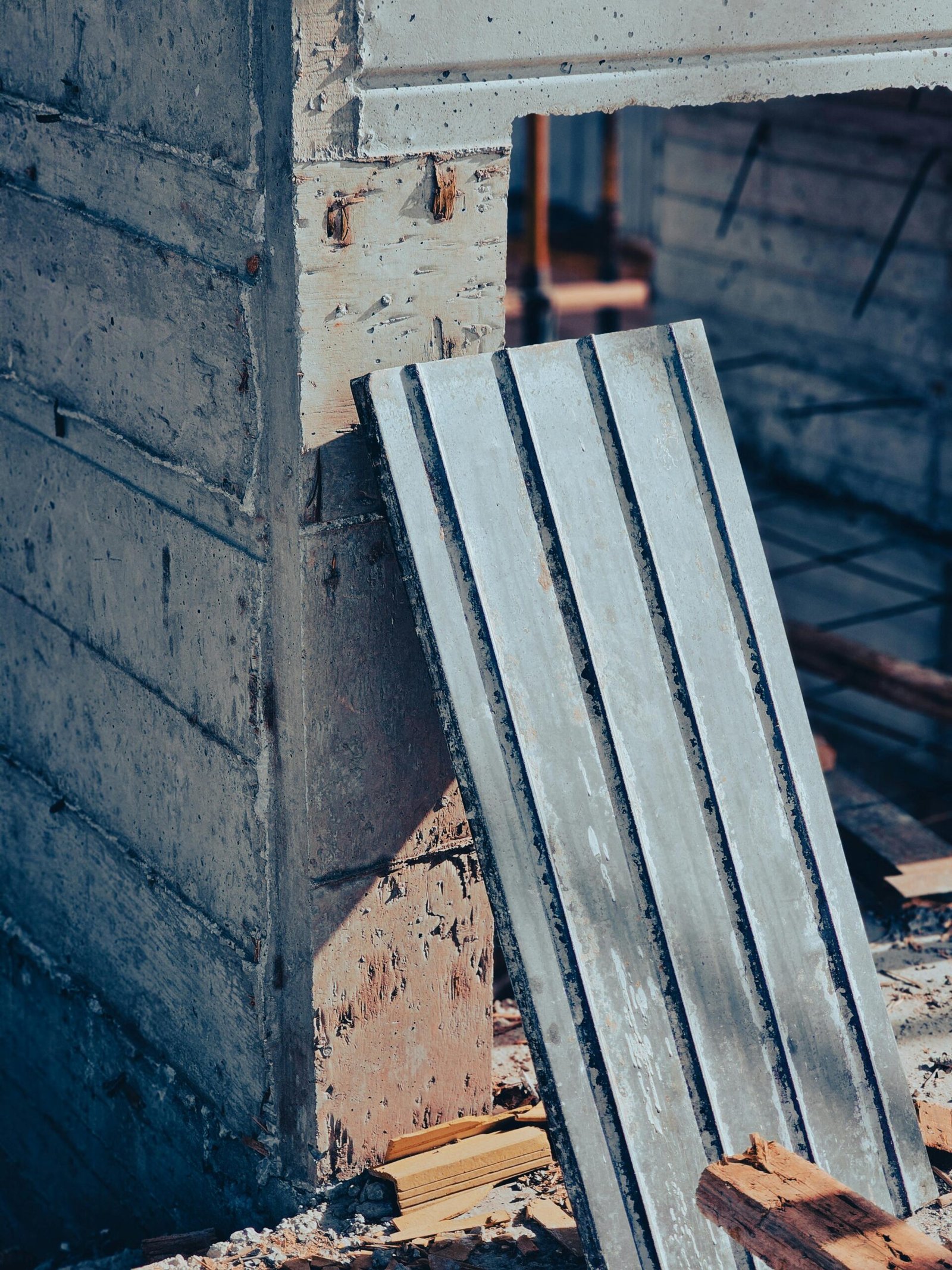 A close-up shot of a construction site featuring a concrete wall and building materials.