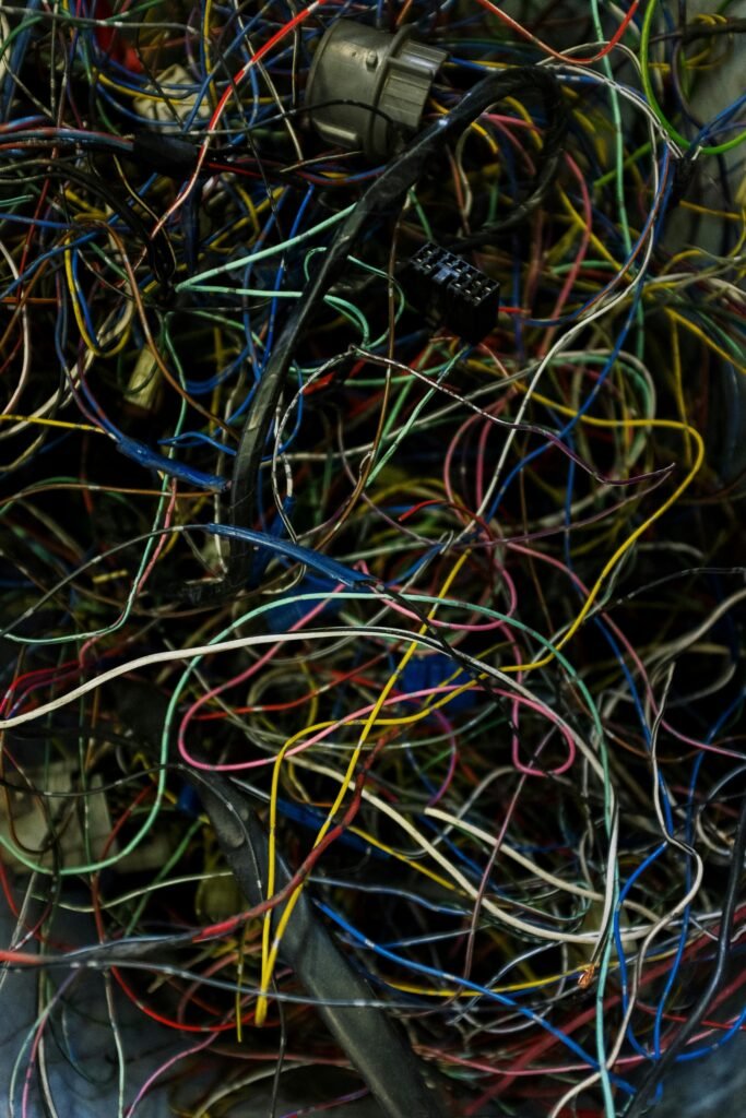 Close-up view of colorful tangled electrical wires showcasing chaos and complexity.