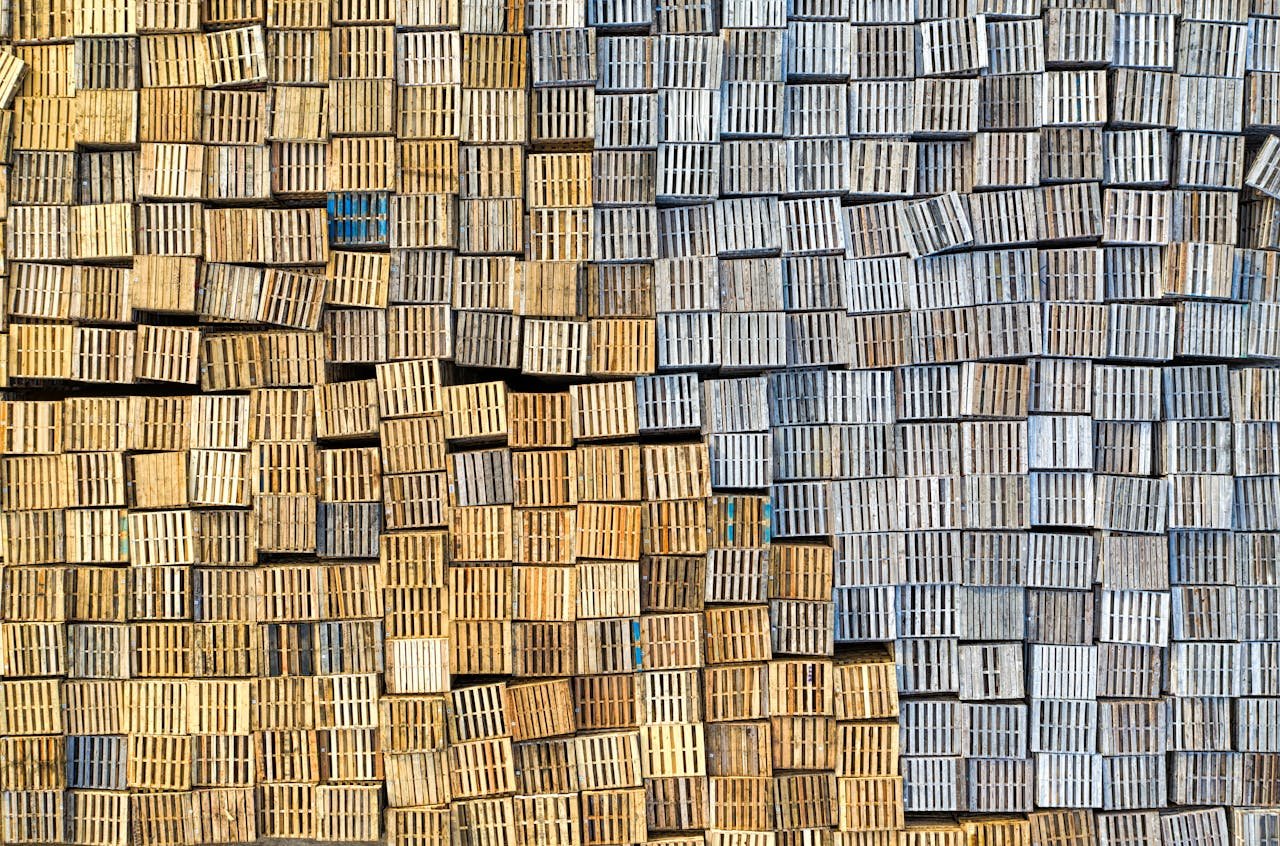 Aerial view of stacked wooden pallets creating a textured pattern outdoors.